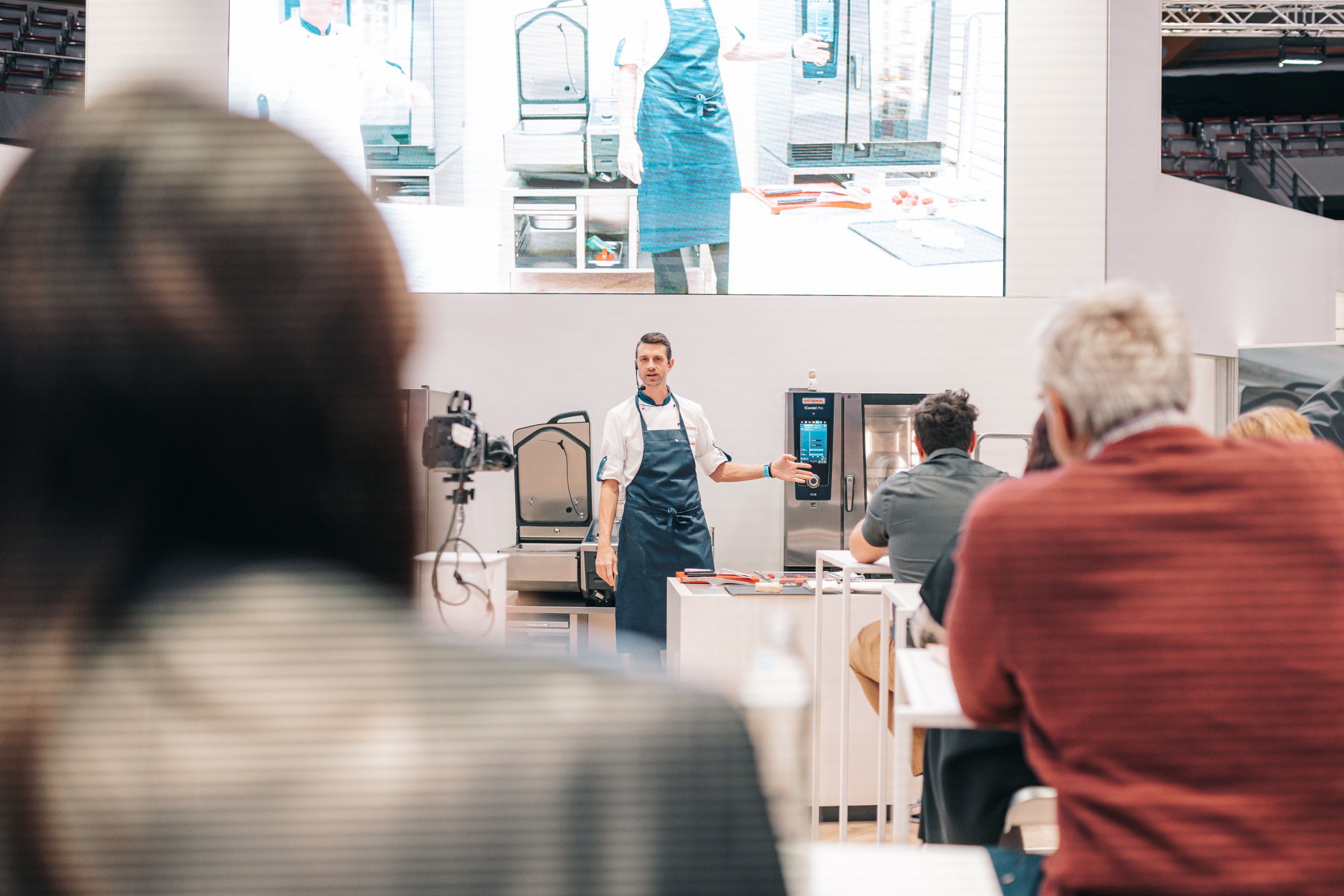 Rational employee presents professional kitchen appliances at "Alles für den Gast" 2022 