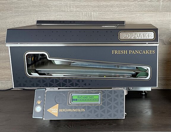 Pancake Maschine für frische heiße Pancakes per Handzeichen. Offizieller Partner von Popcake.